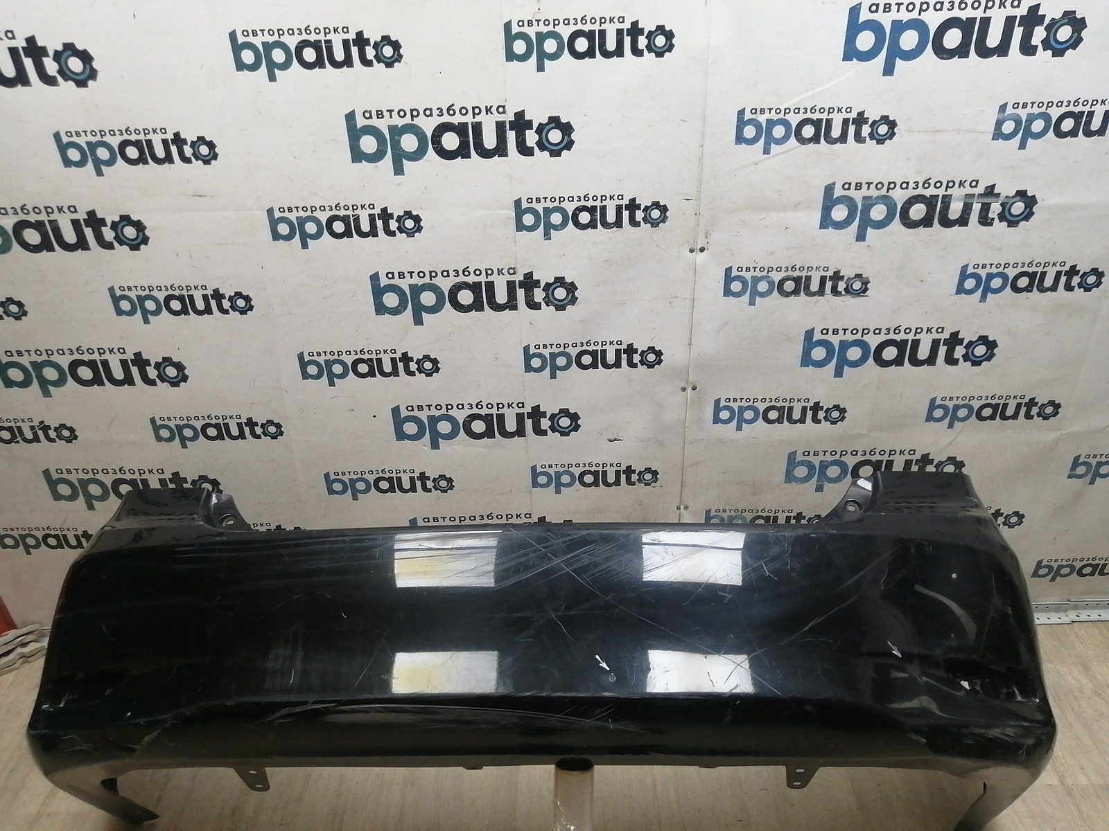 Пример детали Бампер задний; без паркт. (52159-12B30); Toyota Corolla 150 рест. (2010-2013) /AA045905/ БУ; Оригинал; Р1, Мелкий дефект; 