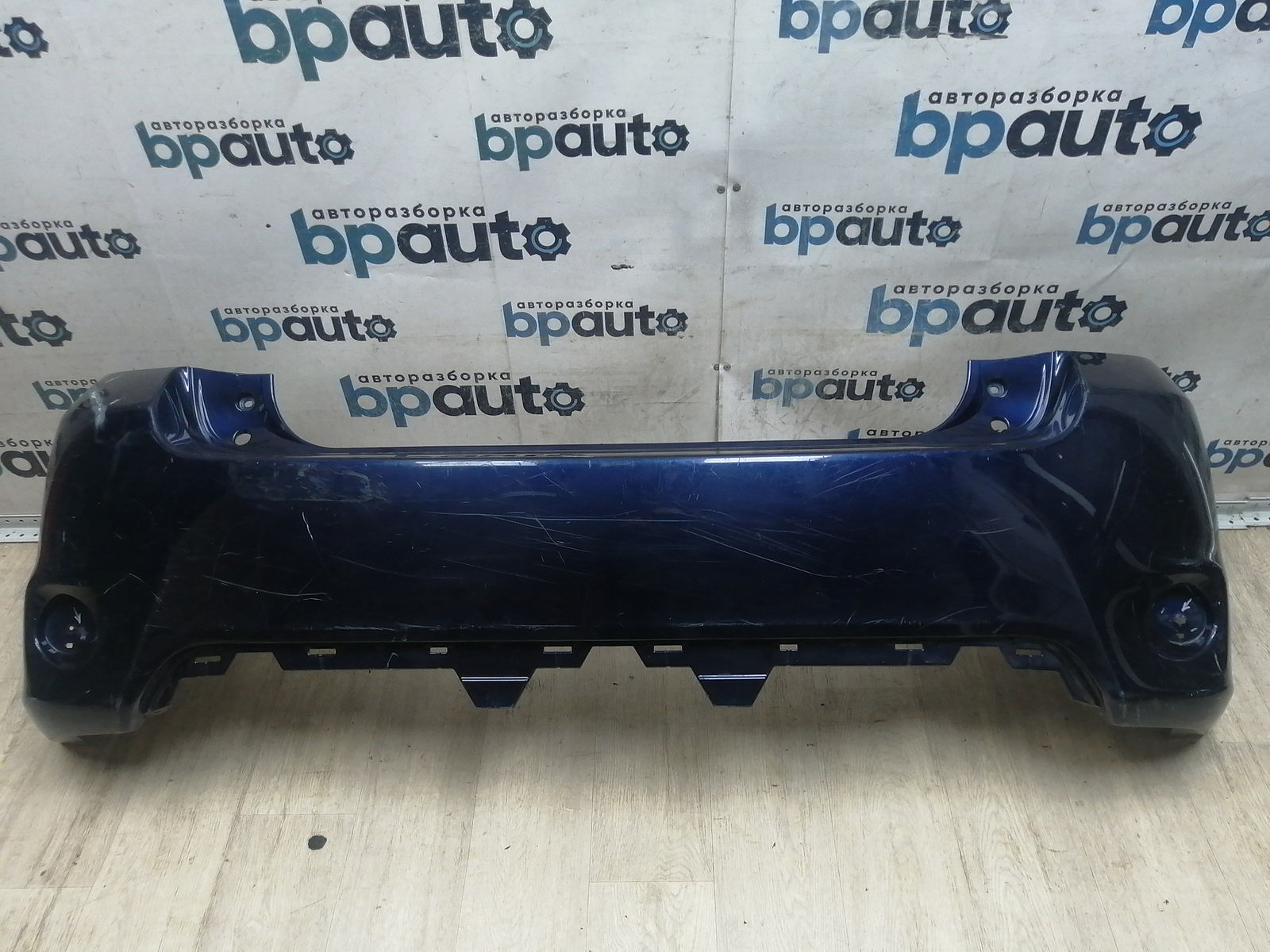 Пример детали Бампер задний; без паркт. (52159-02610); Toyota Auris I рест. (2010- 2013) /AA046023/ БУ; Оригинал; Р1, Мелкий дефект; ДхШхВ 1,8х0,54х0,57; 