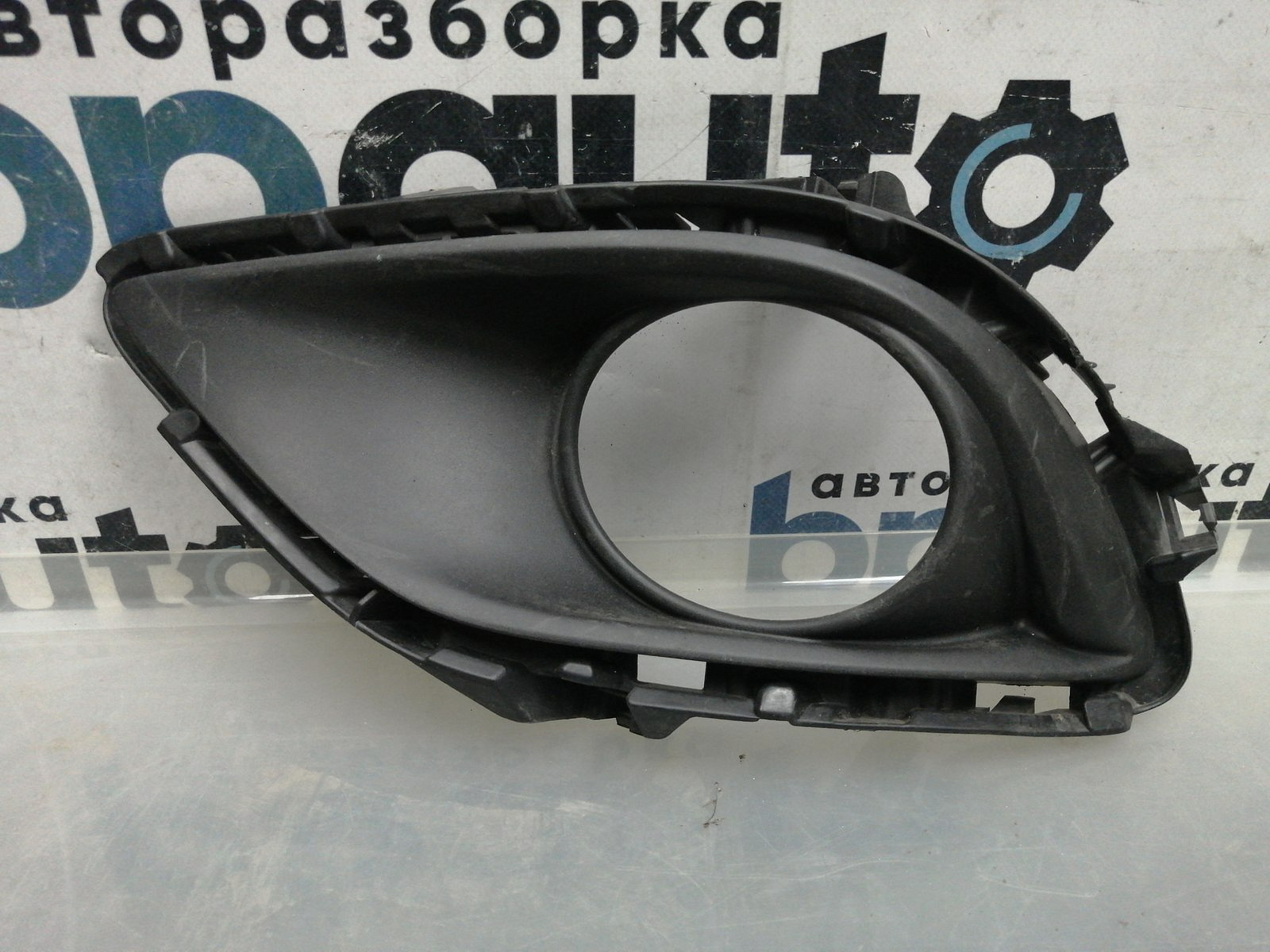 Фотография детали AA045586; Накладка ПТФ левая (TK22-50C21) для Mazda CX-9 I рест. (2012-2016)/БУ; Оригинал; Р1, Мелкий дефект; . Фото номер 1